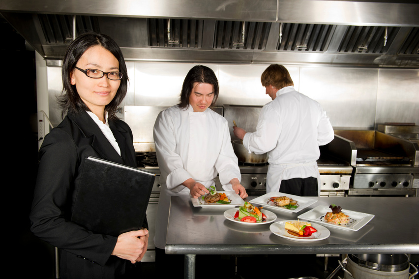 Restaurant manager with professional chefs working